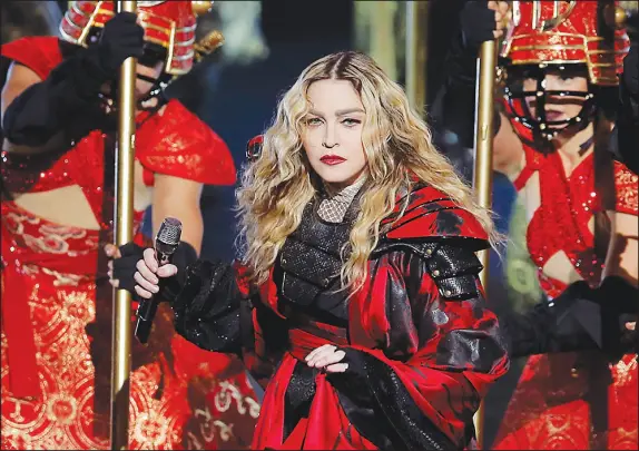  ?? KIN CHEUNG / ASSOCIATED PRESS FILE (2016) ?? Madonna performs during the 2016 Rebel Heart World Tour in Macau, China. Madonna, tour promoter Live Nation and Barclays Center in Brooklyn were accused in a lawsuit Jan. 17 in U.S. District Court of Eastern New York of “unconscion­able, unfair, and/or deceptive trade practices” for the delayed start of a scheduled 8 p.m. concert at 10:50 p.m.