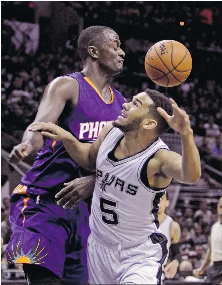  ?? — THE CANADIAN PRESS FILES ?? San Antonio Spurs’ Cory Joseph, right, loses the ball against the Phoenix Suns’ Earl Barron during a 2015 game in San Antonio. Joseph, a product of Pickering, Ont., has agreed to a four-year contract worth $30-million US with his hometown Toronto...