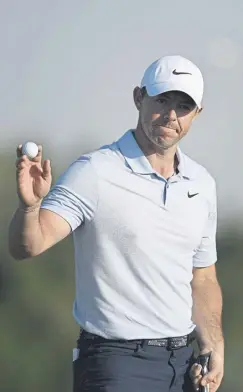  ?? ?? Rory Mcilroy acknowledg­es the crowd after putting out on the 18th green on day two of the Dubai Invitation­al at Dubai Creek Golf and Yacht Club