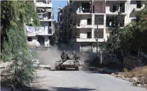  ?? – AFP ?? MAKING ADVANCE: Syrian pro-government forces take part in an operation to take control of Aleppo’s Suleiman Al Halabi neighbourh­ood, which is divided by the frontline that separates the rebelheld east and regime-held west of the northern city, on Friday.