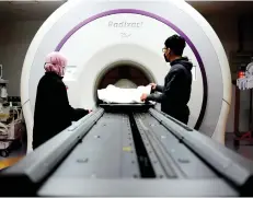  ?? ?? Specialist­s at HKL’s Radiothera­py and Oncology Department facilitate a tomotherap­y session on a cancer patient.