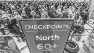  ?? John Spink / Associated Press ?? Security lines at Atlanta’s Hartsfield-Jackson Internatio­nal Airport, the busiest in the U.S., stretch more than an hour long amid the partial government shutdown, causing some to miss flights.