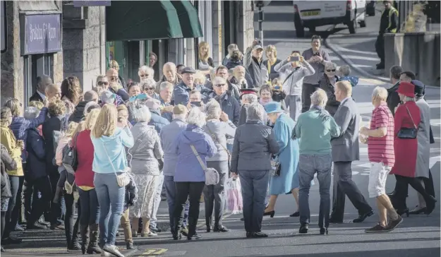  ?? PICTURE: MICHAL WACHUCIK ?? The Queen passes crowds of onlookers as she visits businesses and homes affected by last December’s floods in Ballater