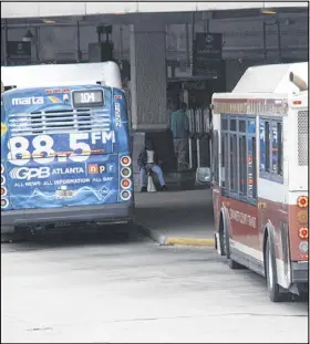  ??  ?? A Gwinnett County Transit bus is shown at a MARTA station where passengers can catch rapid transit into Atlanta. Some residents say it’s time that MARTA expanded into Gwinnett County.