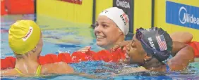  ?? MICHAEL SOHN/THE ASSOCIATED PRESS ?? The United States’ Simone Manuel, right, is congratula­ted by Sweden’s silver medal winner Sarah Sjostrom, left, and Denmark’s bronze medal winner Pernille Blume after winning the gold medal in the in the women’s 100-meter freestyle Friday at the World...