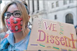  ?? MARY ALTAFFER/AP ?? A demonstrat­or holds a sign at the women’s march Saturday in New York City.