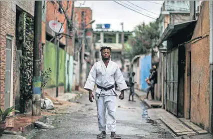  ?? Photo: Pilar Olivares/Reuters ?? Popole Misenga, a refugee from the DRC, near his home in Rio de Janeiro.