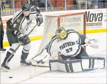  ??  ?? UPEI Panthers goaltender Simon Hofley steers the puck to defenceman Andrew Picco during the second period of an Atlantic University Sport exhibition game against the Saint Mary’s Huskies on Wednesday in Truro, N.S.