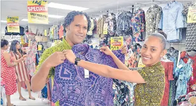  ?? Picture: ELIKI NUKUTABU ?? Viliame Hicks, left, is served by Lusiana Senibuli of Nu-look outlet at Damodar City Centre in Suva.