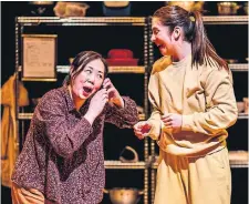  ?? JAE YANG THEATRE PASSE MURAILLE ?? Phoebe Hu, left, plays Ma, and Madelaine Hodges plays her youngest daughter, Iris, in “Woking Phoenix” at Theatre Passe Muraille. While the play isn’t built on narrative punches or inciting incidents, its story is about the family’s journey itself.