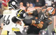  ?? Jason Miller / TNS ?? Browns defensive end Myles Garrett, right, hits Steelers quarterbac­k Mason Rudolph (2) over the head with his helmet during a Nov. 14 game.