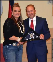  ?? JEFF RICE — JOURNAL-ADVOCATE ?? Chief Kerr gives Officer Makayla Chartier a ceremonial flag embedded with K-9glock’s service badge.