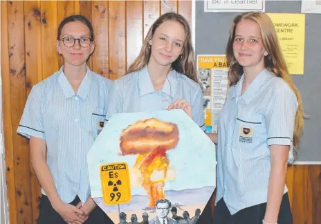  ??  ?? Palm Beach Currumbin students Isabelle Richters, Lily de Groot and Jaime Pryor holding the tile they created for element 99 – einsteiniu­m — for the University of Waterloo Timeline of Elements project.