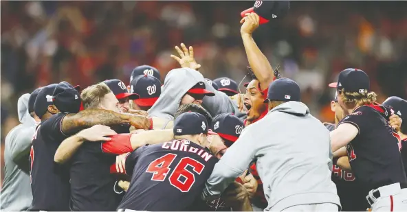  ?? ELSA/GETTY IMAGES ?? The Washington Nationals celebrate after defeating the Astros 6-2 in Game 7 to win the World Series on Wednesday night at Minute Maid Park in Houston.