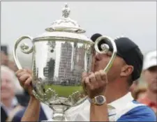  ?? JULIO CORTEZ — THE ASSOCIATED PRESS ?? Brooks Koepka lifts the trophy after winning the PGA Championsh­ip at Bethpage Black on Sunday.