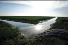  ?? AP PHOTO/RICH PEDRONCELL­I ?? In this Feb. 25, 2016, file photo, water flows through an irrigation canal to crops near Lemoore. The Santa Clara Valley Water District board may reverse an earlier decision and grant its full support to Gov. Jerry Brown’s controvers­ial plan to build...