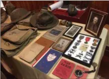  ?? PAUL POST PHOTO ?? Charles Wheeler Jr. owns much of the equipment his grandfathe­r used during World War I including a helmet, field pack, map case, boots, gas mask and various printed materials.