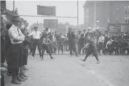  ??  ?? Boys flock to the Elizabeth St. playground for a game of baseball in 1913.