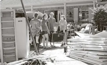  ?? Kirk Sides / Houston Chronicle ?? Clear Springs volleyball players, including Oceana Lew, Keri Spitler and Madison Williams, help with the cleanup at the home of former Clear Creek ISD Athletic Director Bill Daws in League City.