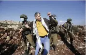  ?? MAJDI MOHAMMED AP ?? Israeli soldiers arrest a Palestinia­n during a protest against the expansion of Jewish settlement­s near the West Bank town of Salfit on Nov. 30.