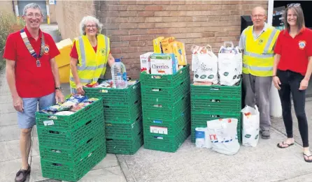  ??  ?? Lions President Peter Fisher left and fellow Lions pictured with some of the donated goods