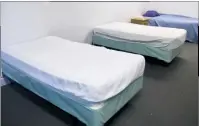  ??  ?? Two empty beds sit next to an occupied bed in a male dorm room at Carol Porto Treatment Center in Prince Frederick on March 9. Program Director Carol Porto said half of her facility’s beds are empty because people can’t afford to pay for the treatment.