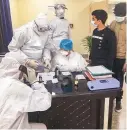  ?? PHOTO:PTI ?? Indians, airlifted from Wuhan, undergo tests at a quarantine facility in New Delhi