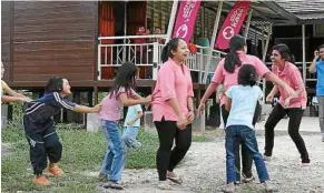  ??  ?? Getting comfortabl­e: Children playing at the completed Astro Hostel building equipped with amenities, utilities, and the Kampus Astro learning system.