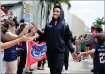  ?? CARLINE JEAN — SOUTH FLORIDA SUN-SENTINEL VIA AP ?? Florida Atlantic guard Brandon Weatherspo­on is greeted by supporters Wednesday, as the team prepares to leave Fort Lauderdale, Fla., to head to New York for an NCAA tournament game against Northweste­rn.