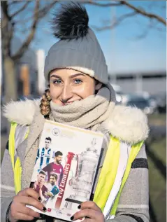  ??  ?? Still on a high: Jessica Burgess sells programmes yesterday from the victory over City