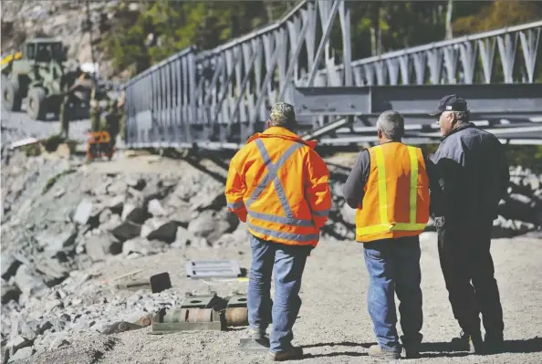  ?? Angela Abbey/Canadian Forces/files ?? Workers observe the progress of an Acrow bridge in Petite Forte, N.L. A court dismissed the case against Atlantic Industries Limited and AIL Internatio­nal Inc, both of New Brunswick, after they said they did not have any data belonging to their U.S. rival Acrow.