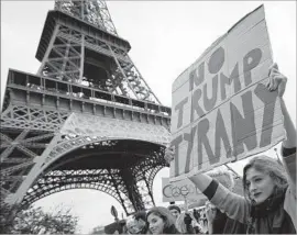  ?? Ian Langsdon European Pressphoto Agency ?? ABOUT 1,000 demonstrat­ors and a large group of American expatriate­s took part in a march against President Trump in front of the Eiffel Tower in Paris.