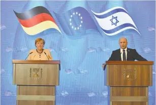  ?? (Yoav Dudkevitch/Pool) ?? PRIME MINISTER Naftali Bennett and German Chancellor Angela Merkel hold a joint news conference at the King David Hotel in Jerusalem on Sunday.