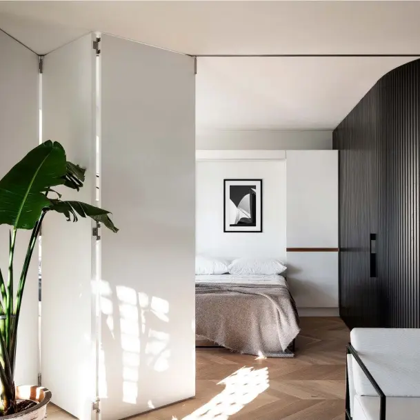  ??  ?? These pages, clockwise from left The dining area is easily converted into a second bedroom by folding down the Murphy bed and enclosing the space with internal bifold doors. The artwork above the bed is by Tom Ferguson and the Society Limonta throw is from Ondene. Bathroom walls are covered in matt-white tiles from Bettertile­s and paired with Manhattan limestone flooring from Sareen Stone. In the master bedroom, a ‘Mondrian’ bedside table from Poliform accompanie­s a B&B Italia ‘Charles’ bed from Space. DCW Éditions ‘Mantis BS3’ table lamp and Injiri Meghwal throw, both from Spence & Lyda.