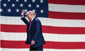  ?? Photograph: Sergio Flores/AFP/Getty Images ?? Donald Trump waves after speaking at the Iowa Republican party’s Lincoln Dinner in Des Moines on Friday night. In general election polling, Biden and Trump are closely matched.