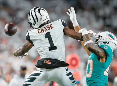  ?? DOLPHINS FREE-AGENCY GLIMPSE CORNERBACK­S JEFF DEAN/AP ?? Dolphins cornerback Nik Needham breaks up a pass intended for Bengals wide receiver Ja’Marr Chase on Sept. 30.