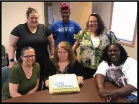  ?? SUBMITTED — NEIGHBORHO­OD ALLIANCE ?? Sandy Humphrey, center holding cake, director of shelter and emergency services at Neighborho­od Alliance, is retiring after 21 years of service.