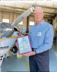  ?? Shelly Thorene / Union Democrat ?? Ed Gregory, 75, of Groveland, holds an award for 50 years of safe flight in front of his hangar ontuesday.