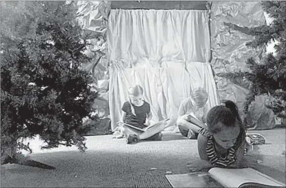  ?? Photo submitted ?? Stomie Everle (in front), Josephine Mitzner and Logan Reynolds read in their classroom after teacher Rachel Welch transforme­d it into a campground.