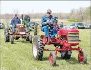  ?? (File Photo/NWA Democrat-Gazette/Randy Moll) ?? Don Christense­n of Gentry drives an electric tractor during the parade of power at noon on Friday at the spring show of the Tired Iron of the Ozarks in Gentry. He converted the 1949 Farmall Cub to an electric-powered tractor in 2015 and has entered it in the show and numerous parades.