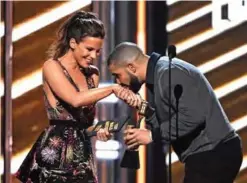  ??  ?? Drake kisses presenter Kate Beckinsale's hand as he walks on stage to accept the award for Top Male Artist.