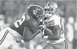  ??  ?? Alabama defensive lineman Quinnen Williams, tackling Clemson running back Adam Choice, had eight sacks this season. MARK REBILAS/USA TODAY SPORTS