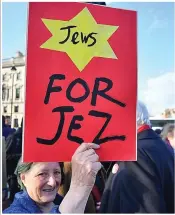  ??  ?? One placard carries a yellow star, a provocativ­e symbol of Jewish suffering