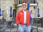  ?? RACHEL RAVINA MEDIANEWS GROUP ?? Abington resident and Ambler business owner Paul Mamalou dons a Phillies jacket while walking on Butler Avenue on Monday, a day after the Phillies won the NLCS.