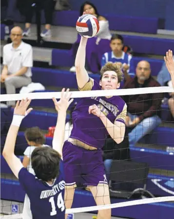  ?? FOR THE U-T ?? St. Augustine's Patrick O'Leary (26) hits over the block of University City's Lincoln Holzman (14).