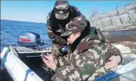  ?? LI JUNXIU / FOR CHINA DAILY ?? Officers of the Heixiazi Island border police watch the opening ceremony of the 19th CPC National Congress on a cellphone during a patrol on Wednesday.