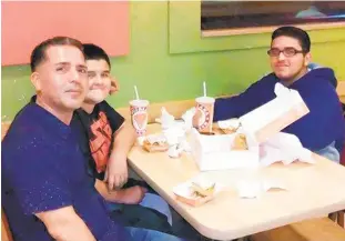  ??  ?? Hewerd (Eddie) Velez has dinner with his two youngest sons Friday night, hours before he died early Saturday morning after being struck on the FDR Drive.