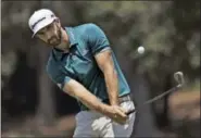  ?? CHRIS O’MEARA — THE ASSOCIATED PRESS ?? Dustin Johnson chips onto the seventh green during a practice round for The Players Championsh­ip golf tournament Wednesday in Ponte Vedra Beach, Fla.