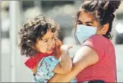  ?? AL SEIB Los Angeles Times ?? ZULEMA CUEVAS helps her 2-year-old daughter, Zulema Williams, with an oral swab for a test.