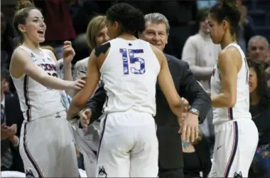  ?? THE ASSOCIATED PRESS ?? FILE - In this file photo, Connecticu­t head coach Geno Auriemma, center, and player Katie Lou Samuelson, left, smile as seniors Gabby Williams, center, and Kia Nurse leave play for the final time in regular season play during the second half an NCAA...